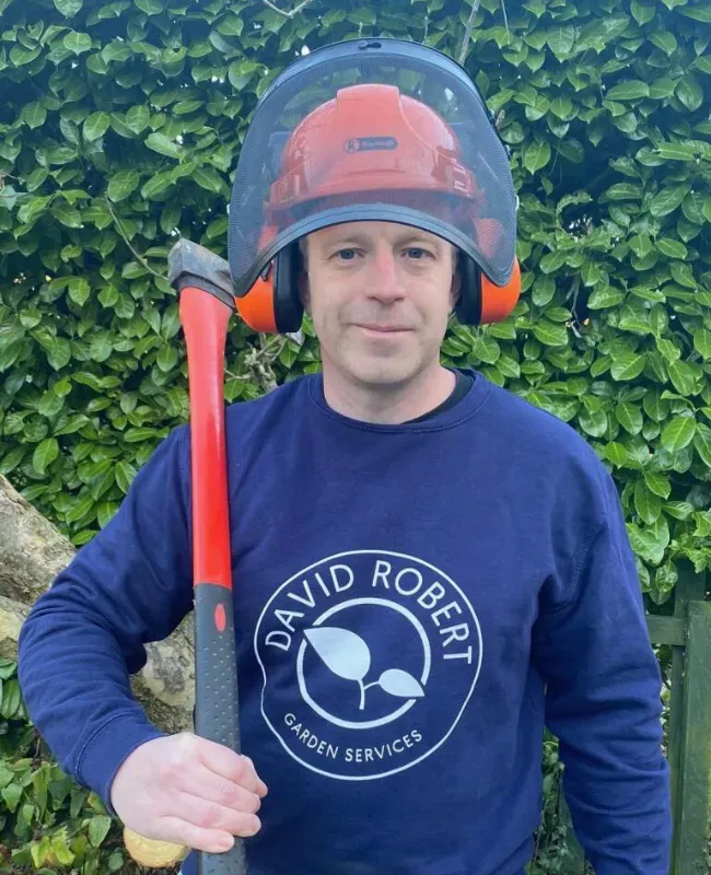 David Robert wearing a helmet and holding an axe over his shoulder